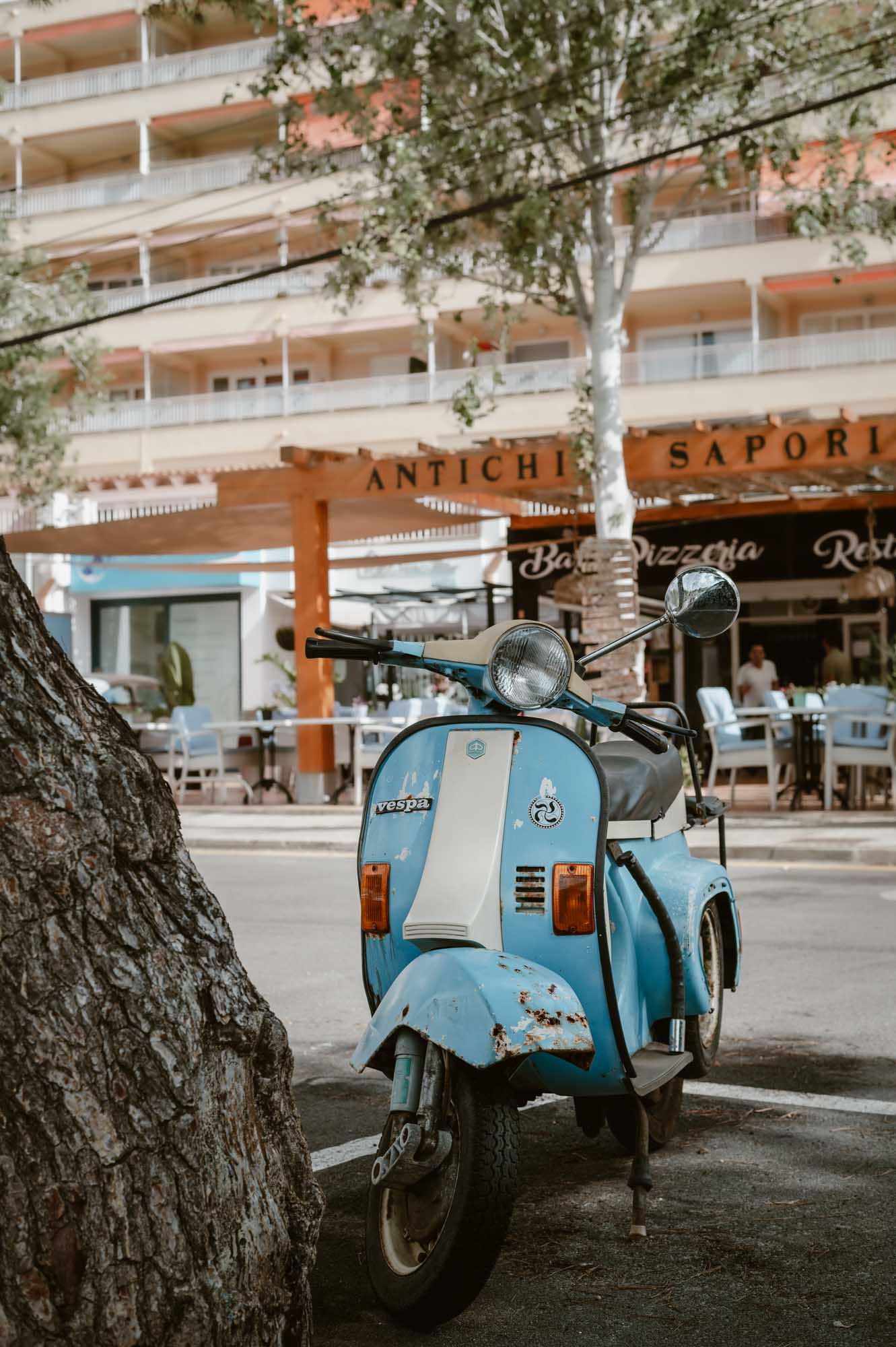 A blue vespa parked on the streets of Cala D'Or in Palma de Mallorca.