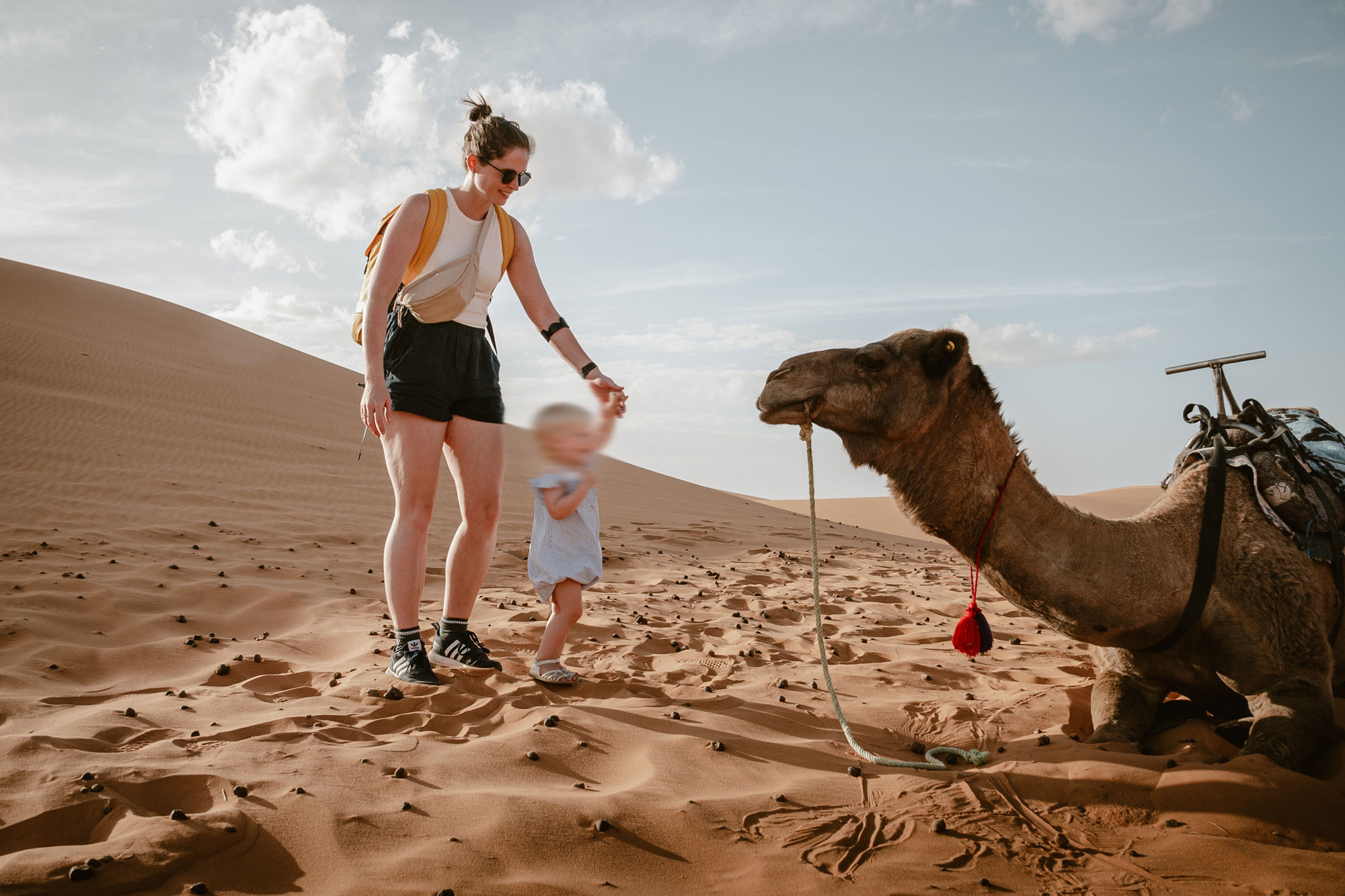 Camel riding in the Moroccan dessert with a toddler