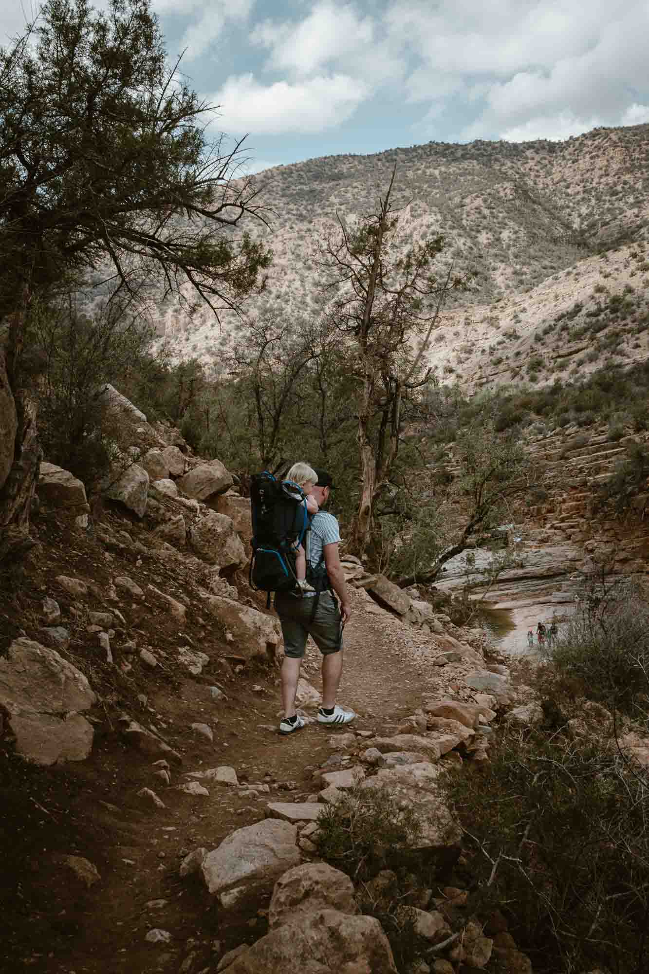 Hike in Moroccan valley with child carrier.