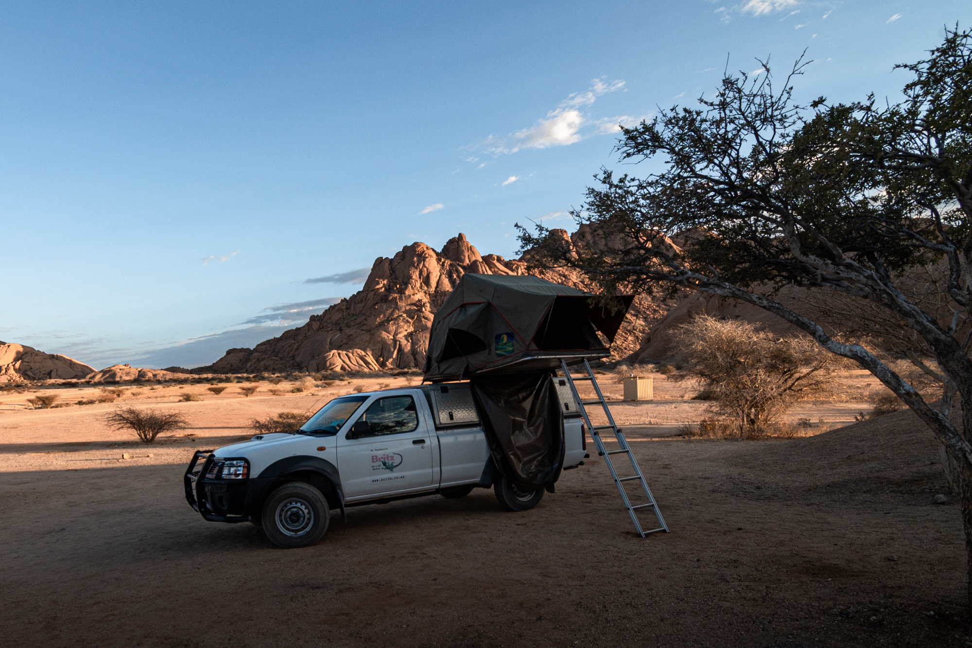 Camping at Spitzkoppe national park with a jeep and roof-top tent.